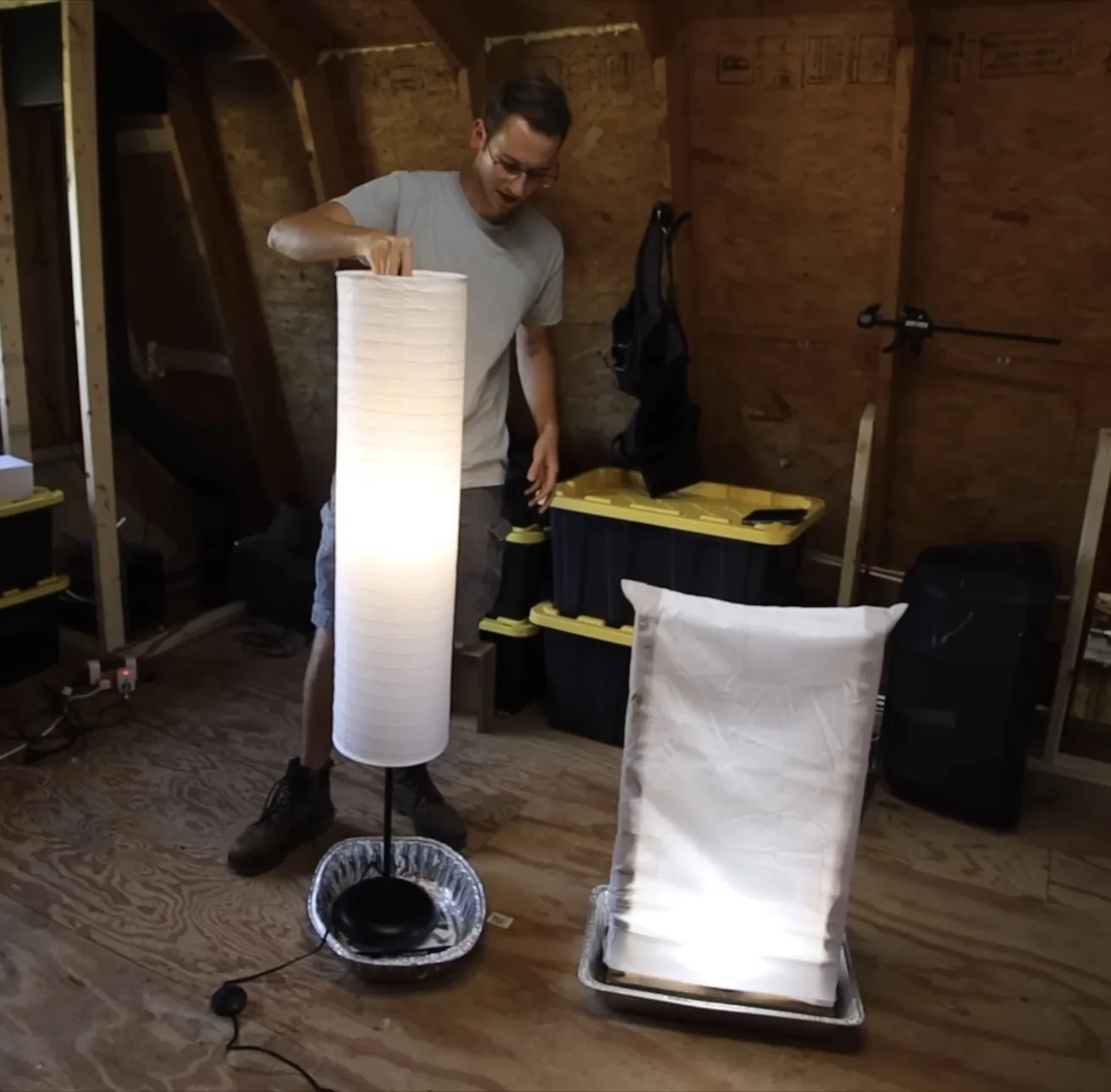 The lit rice paper lamp trap next to a lit pillowcase-on-frame trap, each sitting in a roasting pan